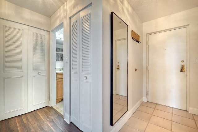 1 Summit Dr Unit 62, Reading, MA 01867 - corridor featuring baseboards and tile patterned flooring
