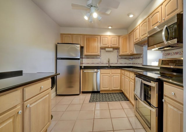 1 Summit Dr Unit 62, Reading, MA 01867 - kitchen with appliances with stainless steel finishes, light brown cabinetry, dark countertops, ceiling fan, and backsplash