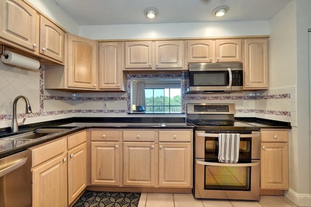 1 Summit Dr Unit 62, Reading, MA 01867 - kitchen with stainless steel appliances, light brown cabinets, tasteful backsplash, dark countertops, and light tile patterned floors