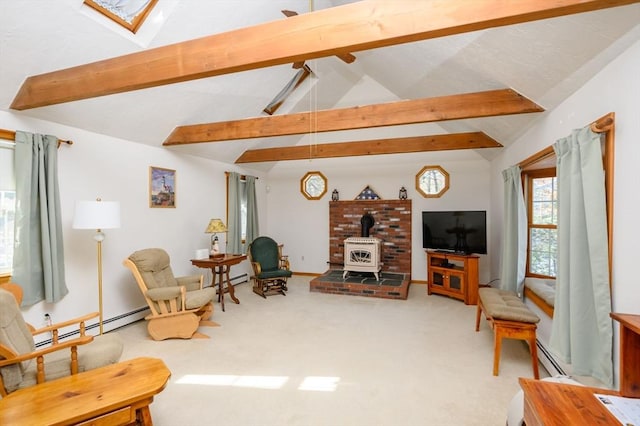 carpeted living room with baseboard heating, vaulted ceiling with skylight, and a wood stove