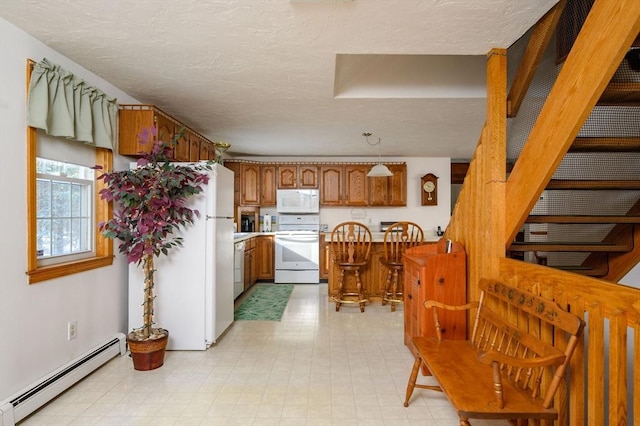 kitchen featuring pendant lighting, white appliances, a baseboard heating unit, a center island, and a textured ceiling