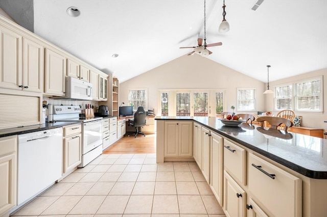 kitchen with white appliances, lofted ceiling, light tile patterned flooring, hanging light fixtures, and cream cabinetry