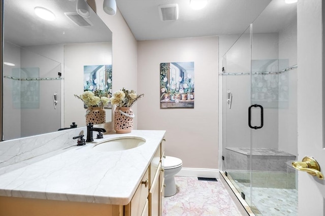 bathroom featuring visible vents, toilet, a stall shower, baseboards, and vanity