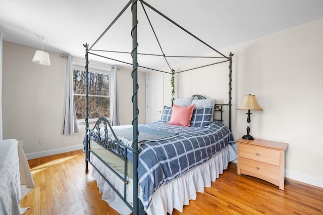 bedroom with wood finished floors and baseboards