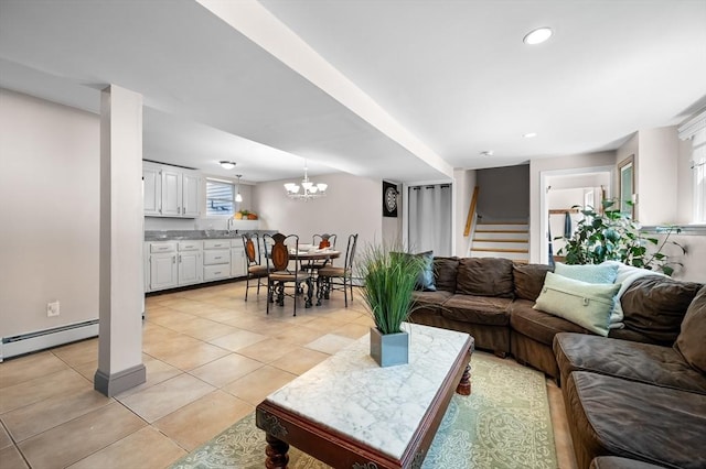 living area featuring stairway, light tile patterned floors, recessed lighting, baseboard heating, and a chandelier