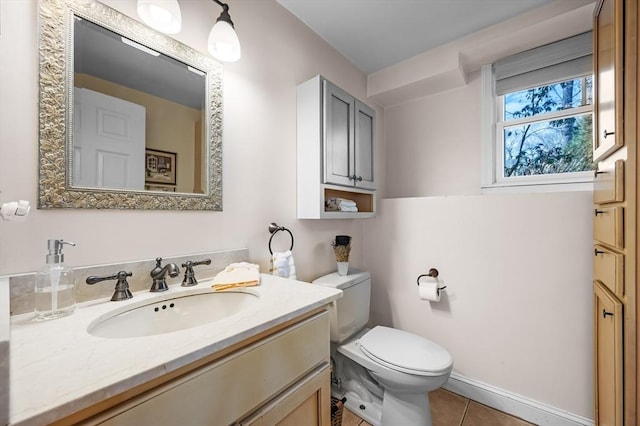 bathroom with vanity, tile patterned floors, toilet, and baseboards