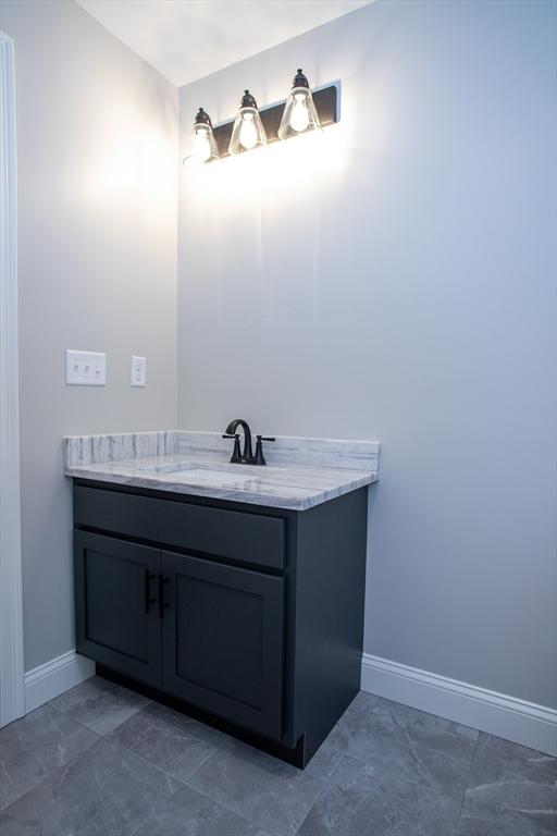 789 Royalston Rd, Phillipston, MA 01331 - bathroom featuring vanity, baseboards, and marble look tiles