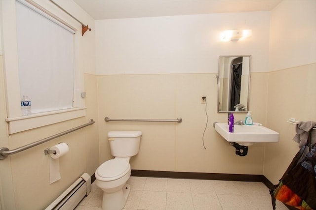 bathroom with a baseboard radiator, toilet, and sink