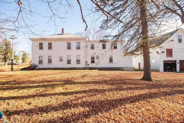 rear view of house featuring a yard