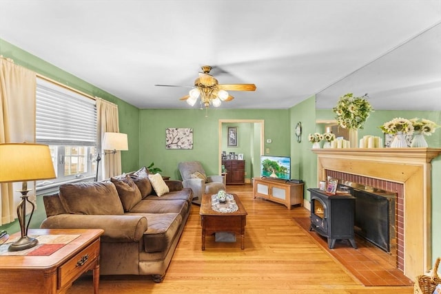 living area featuring ceiling fan and light wood finished floors