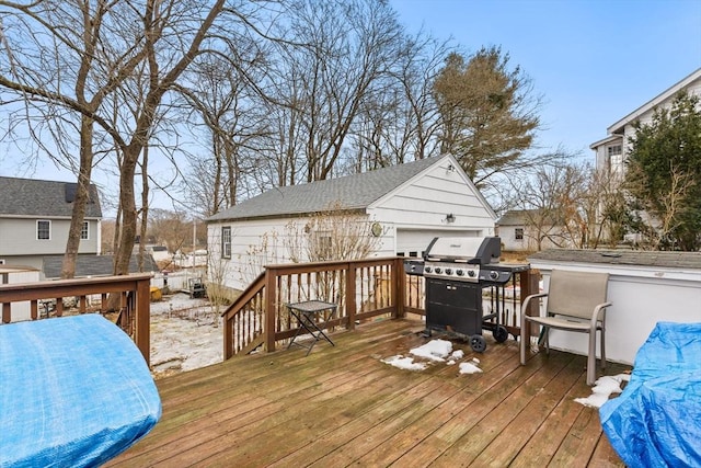 deck with a detached garage and grilling area