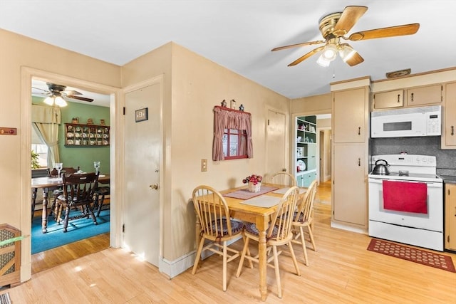 kitchen featuring light wood-style flooring, cream cabinets, backsplash, ceiling fan, and white appliances