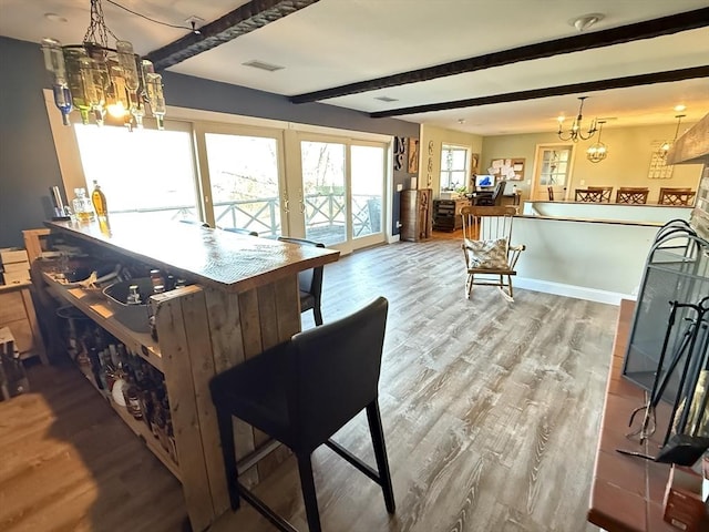 74 Fiske Hill Rd, Sturbridge, MA 01566 - dining room featuring beam ceiling, wood finished floors, french doors, a chandelier, and baseboards