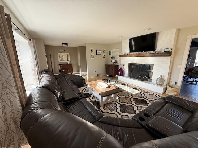 74 Fiske Hill Rd, Sturbridge, MA 01566 - living room featuring a fireplace, baseboards, and wood finished floors