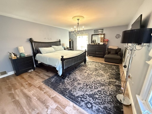 74 Fiske Hill Rd, Sturbridge, MA 01566 - bedroom featuring a chandelier, wood finished floors, and baseboards