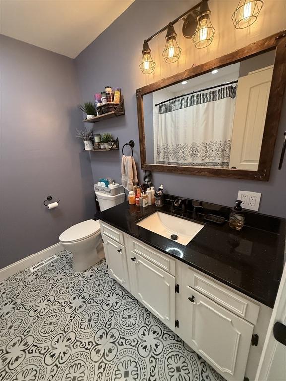 74 Fiske Hill Rd, Sturbridge, MA 01566 - bathroom with vanity, baseboards, toilet, tile patterned floors, and curtained shower