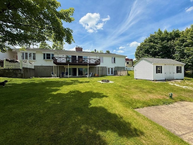 74 Fiske Hill Rd, Sturbridge, MA 01566 - back of property featuring an outdoor fire pit, a wooden deck, an outbuilding, a lawn, and a chimney