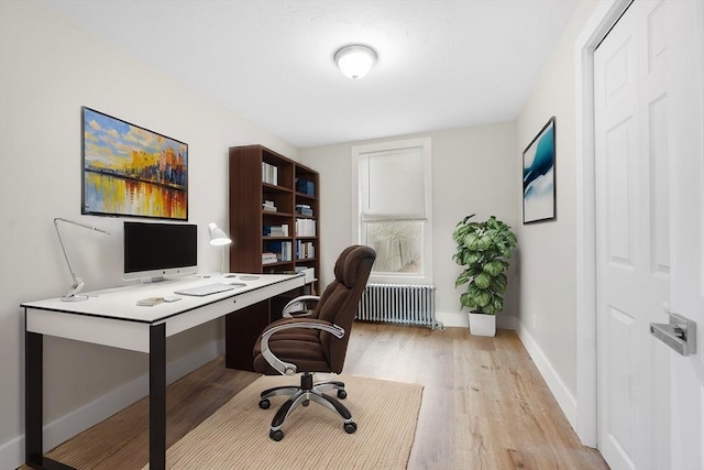 office featuring light wood-type flooring and radiator heating unit