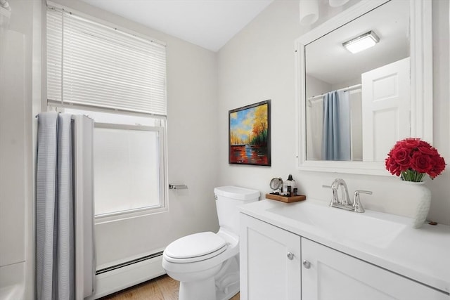 bathroom featuring toilet, hardwood / wood-style floors, a baseboard heating unit, walk in shower, and vanity