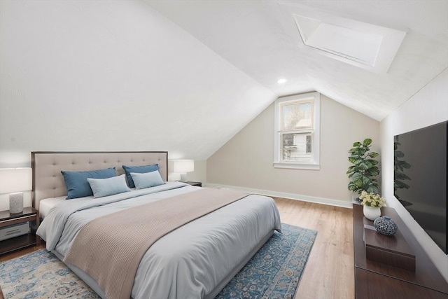 bedroom featuring lofted ceiling and light hardwood / wood-style floors