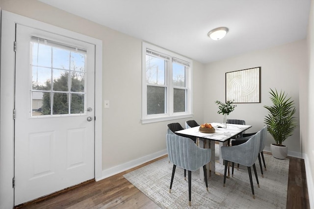 dining space with dark hardwood / wood-style floors