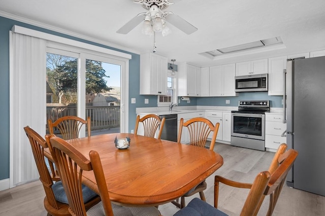 56 Baxter Ave, Yarmouth, MA 02673 - dining area featuring crown molding, a ceiling fan, attic access, a raised ceiling, and light wood-style floors