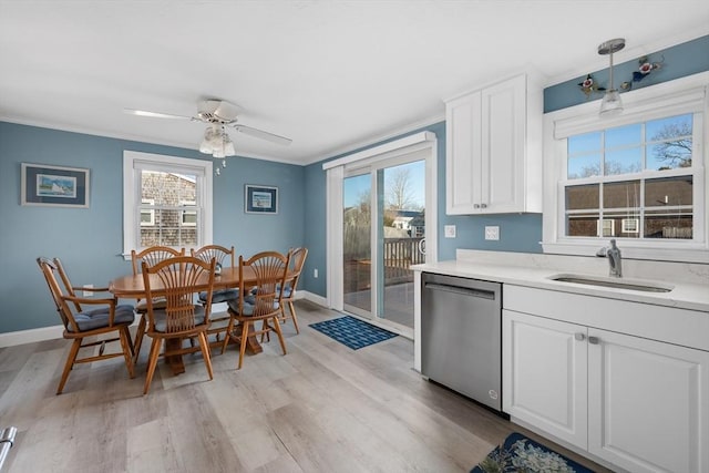 56 Baxter Ave, Yarmouth, MA 02673 - kitchen with crown molding, a sink, dishwasher, light wood-type flooring, and white cabinets