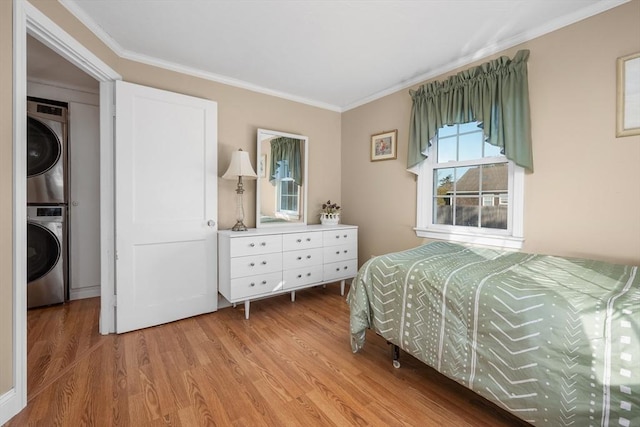 56 Baxter Ave, Yarmouth, MA 02673 - bedroom with light wood-style flooring, crown molding, and stacked washer and clothes dryer