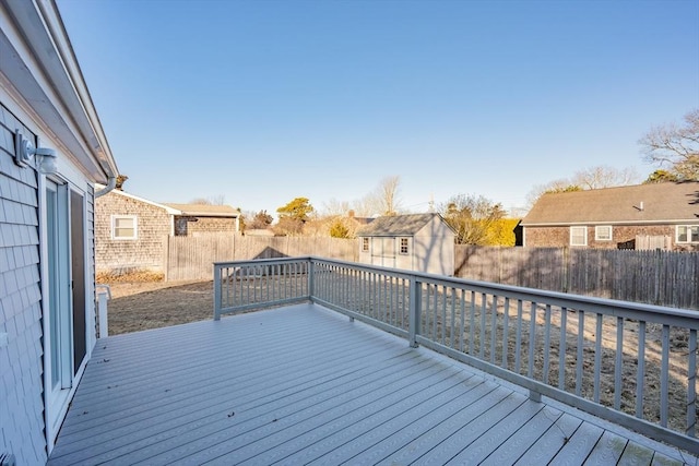 56 Baxter Ave, Yarmouth, MA 02673 - deck featuring a fenced backyard, an outbuilding, a storage unit, and a residential view