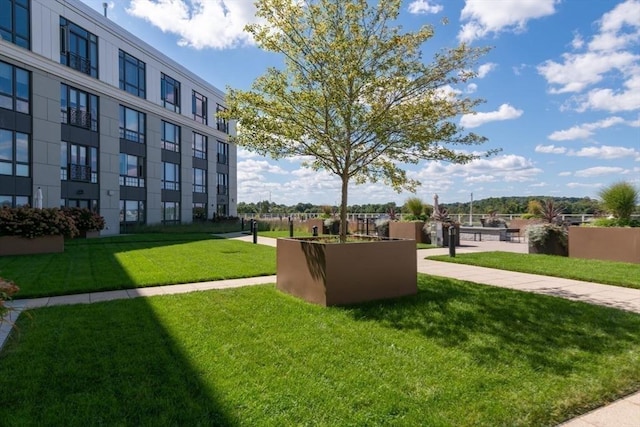 view of home's community featuring a lawn