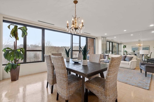 dining space with an inviting chandelier