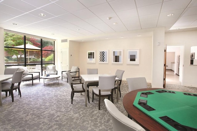 dining space with carpet floors and floor to ceiling windows