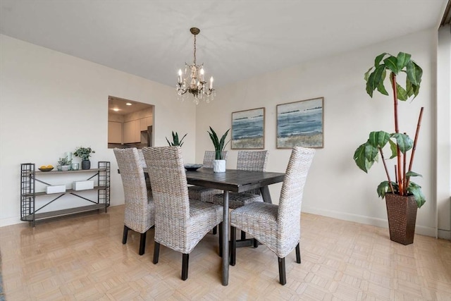 dining area featuring an inviting chandelier and light parquet flooring