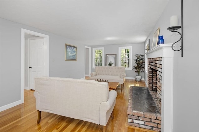 62 Bianca Rd, Duxbury, MA 02332 - living area with light wood-type flooring, baseboards, and a brick fireplace