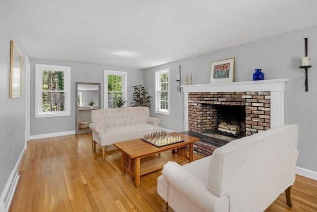 62 Bianca Rd, Duxbury, MA 02332 - living room featuring baseboards, light wood finished floors, and a fireplace
