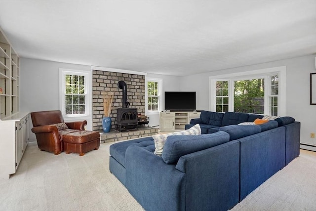 62 Bianca Rd, Duxbury, MA 02332 - living area with light carpet, a wood stove, and healthy amount of natural light