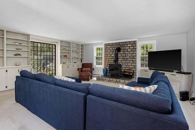 62 Bianca Rd, Duxbury, MA 02332 - carpeted living area with a wood stove and baseboard heating