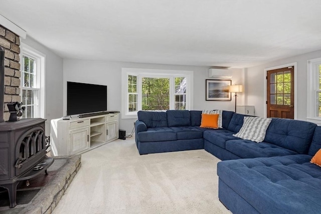 62 Bianca Rd, Duxbury, MA 02332 - living room featuring a wood stove, light colored carpet, healthy amount of natural light, and a wall mounted air conditioner