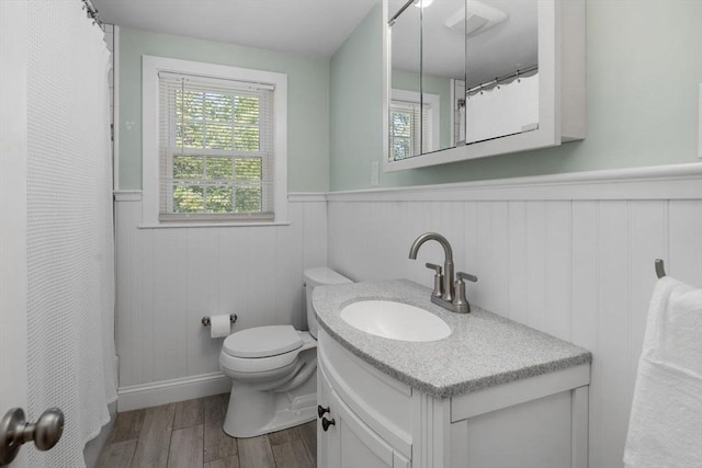 62 Bianca Rd, Duxbury, MA 02332 - full bathroom featuring a wainscoted wall, plenty of natural light, wood finished floors, toilet, and vanity