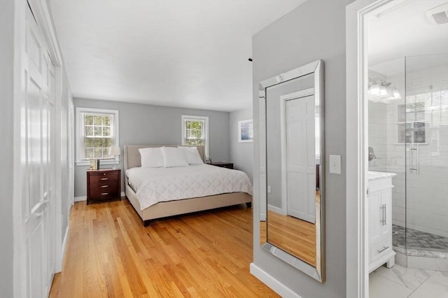62 Bianca Rd, Duxbury, MA 02332 - bedroom featuring ensuite bath, light wood-style flooring, and baseboards
