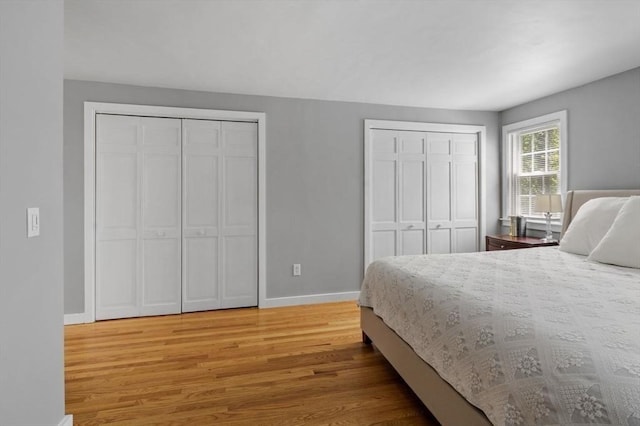 62 Bianca Rd, Duxbury, MA 02332 - bedroom with multiple closets, light wood-style flooring, and baseboards