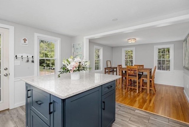 62 Bianca Rd, Duxbury, MA 02332 - kitchen with light wood-style flooring, plenty of natural light, blue cabinets, and a center island