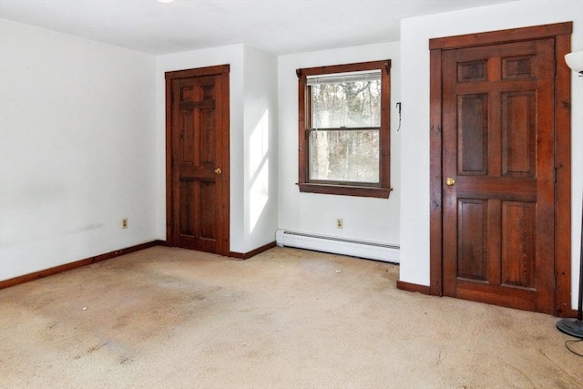 carpeted foyer entrance with a baseboard heating unit