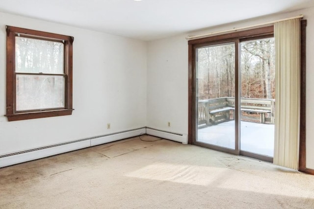 spare room featuring a baseboard radiator and light carpet