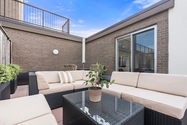 view of patio with an outdoor living space and a balcony