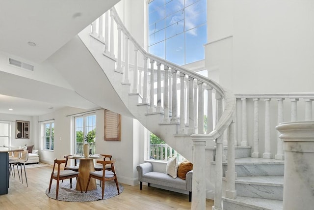 2440 Massachusetts Ave Unit 41, Cambridge, MA 02140 - stairs with wood finished floors and a towering ceiling
