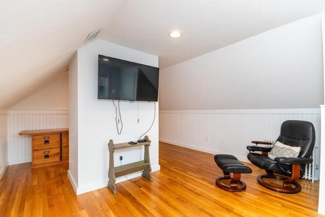 living area with lofted ceiling and light wood-type flooring