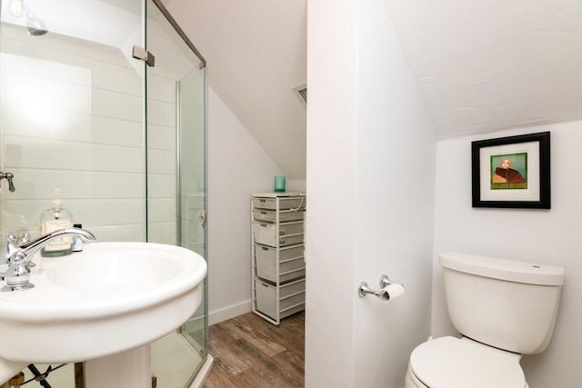 bathroom featuring toilet, a shower with door, sink, and hardwood / wood-style flooring