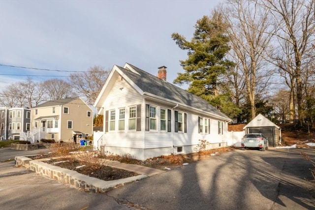 view of side of home with a garage and an outdoor structure