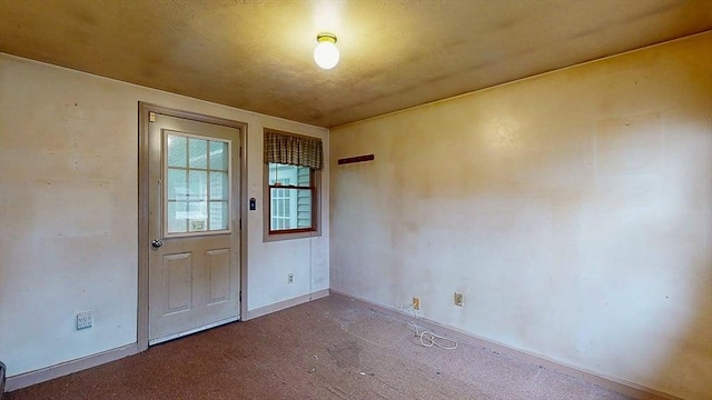 interior space featuring baseboards and carpet flooring